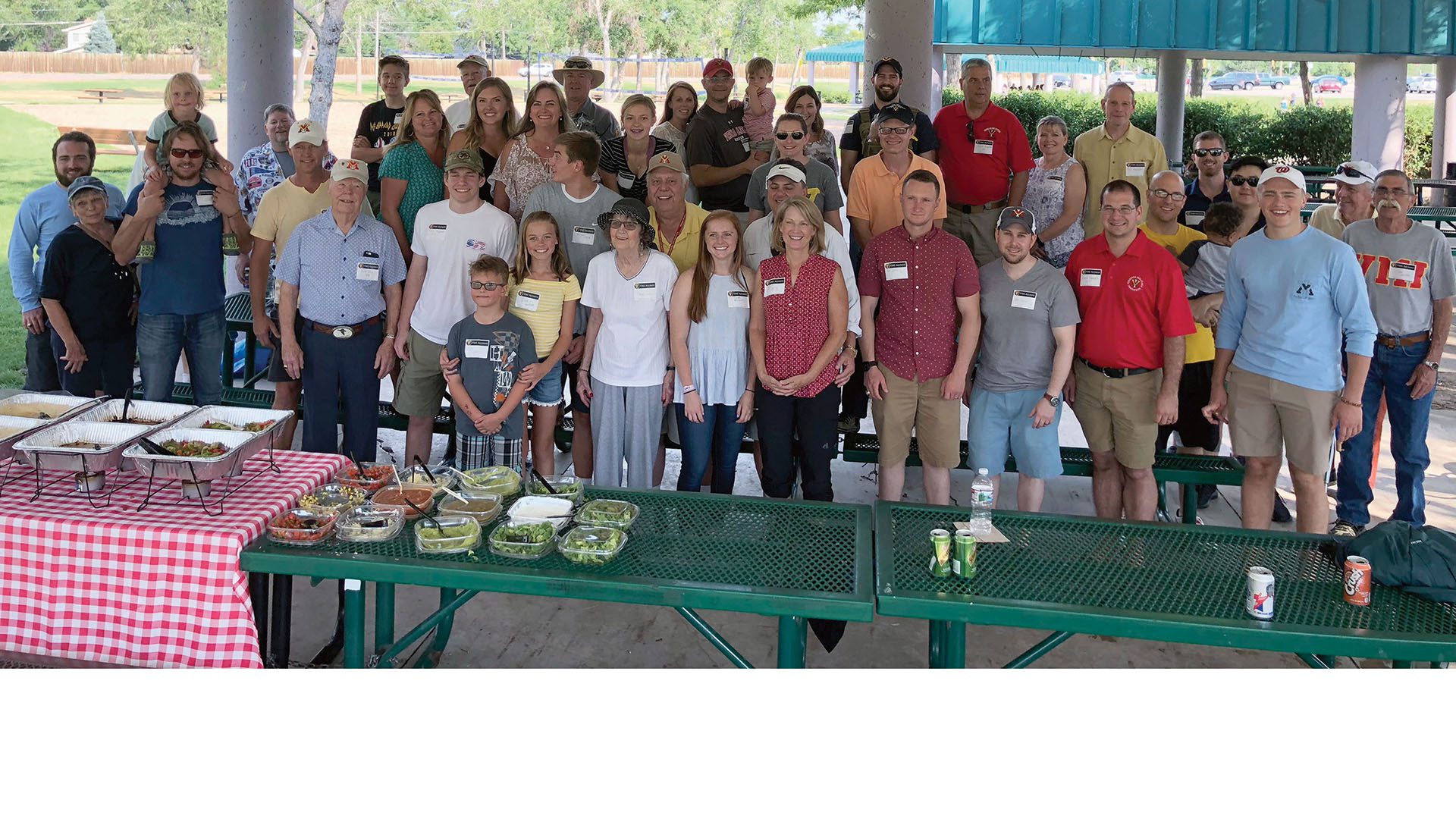 Group of men and women smiling.