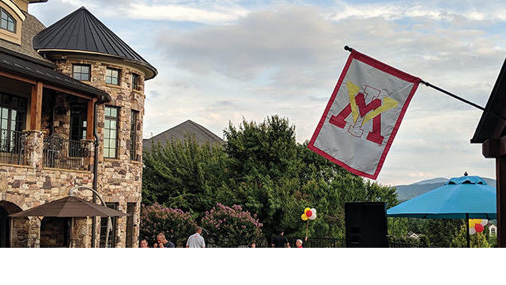 VMI flag flying on side of building.