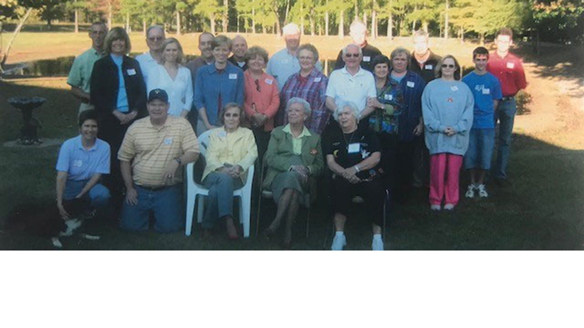 Group of men and women smiling.