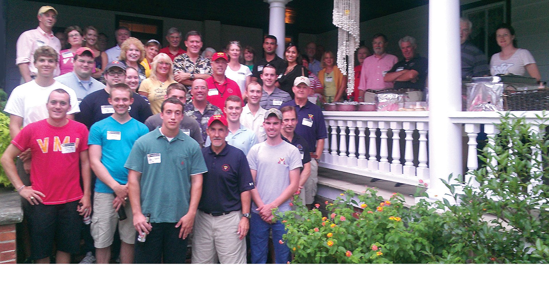 Group of men and women smiling.