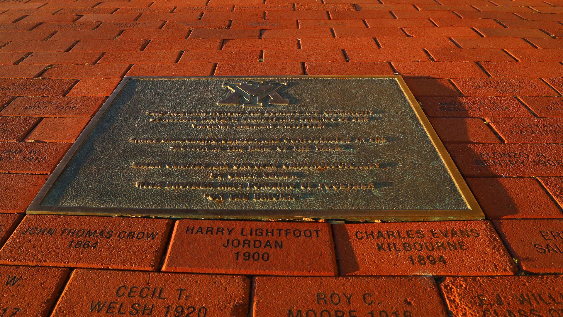 bricks and plaque on ground in front of barracks