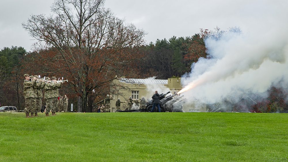 Howitzers being fired and buglers playing