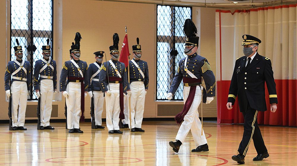 Gen, Moreschi and a cadet walk past the Corps of Cadets