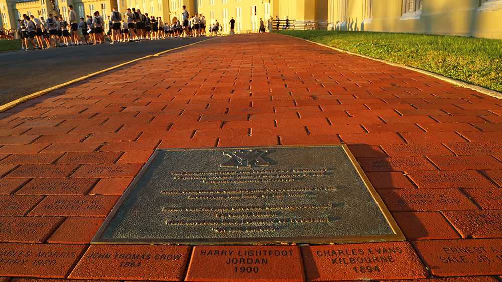 engraved bricks and plaque in ground in front of barracks