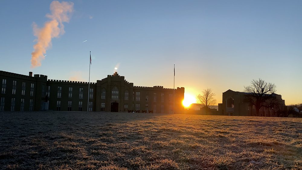 sun rising behind old barracks