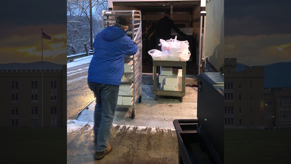 man putting meals in truck