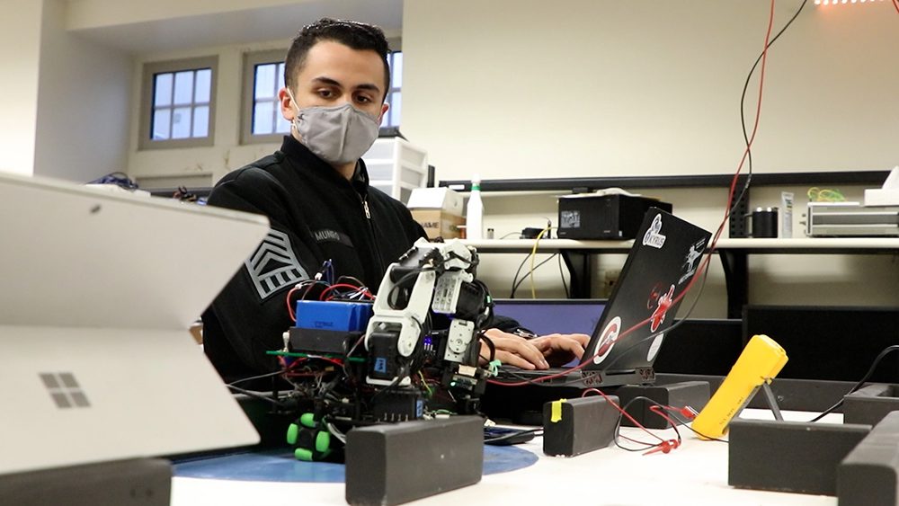 Eric Munro working in robotics lab