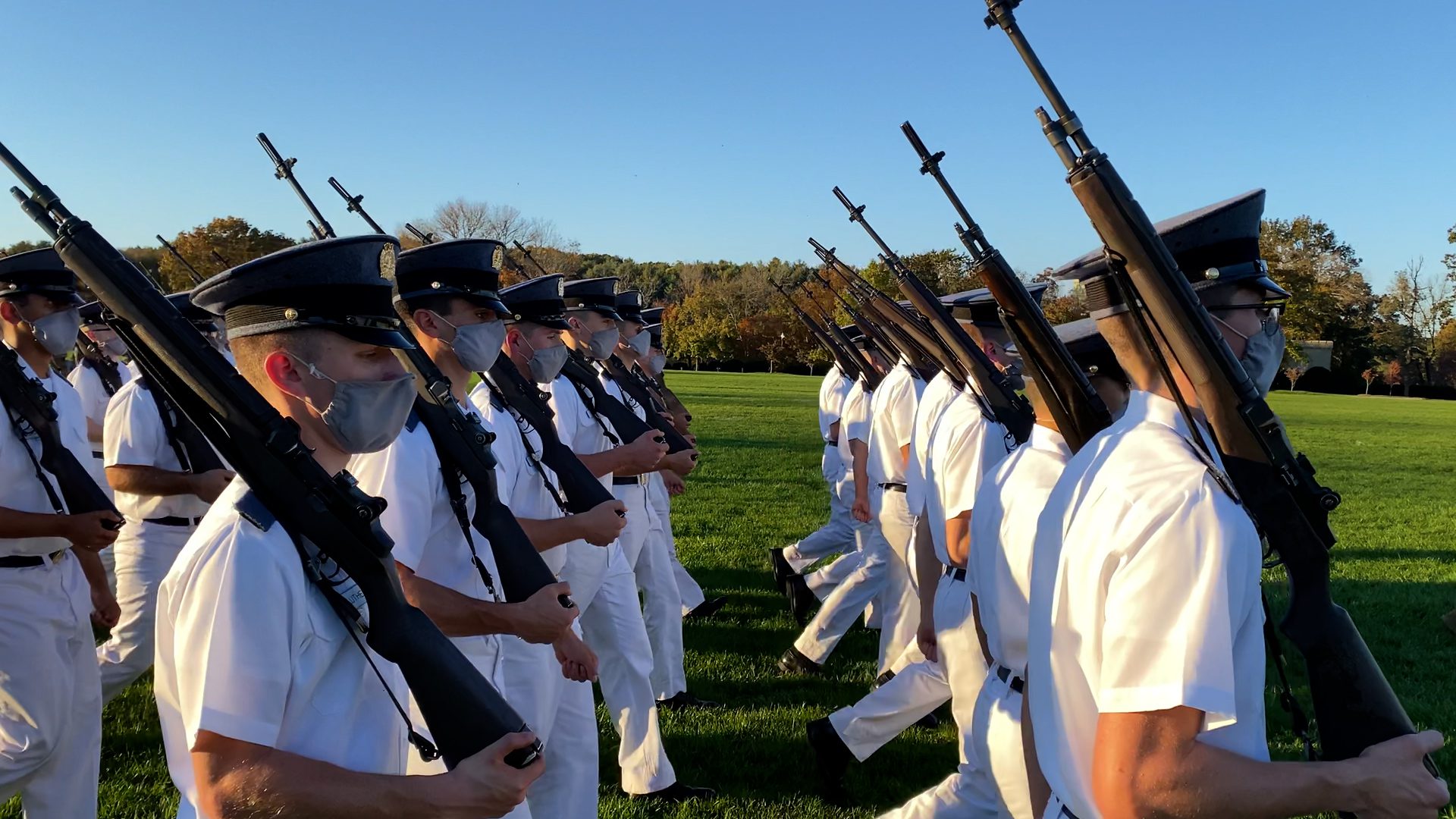 cadets wearing masks, marching with rifles