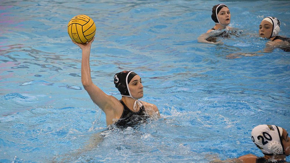 Water polo athlete preparing to throw ball.