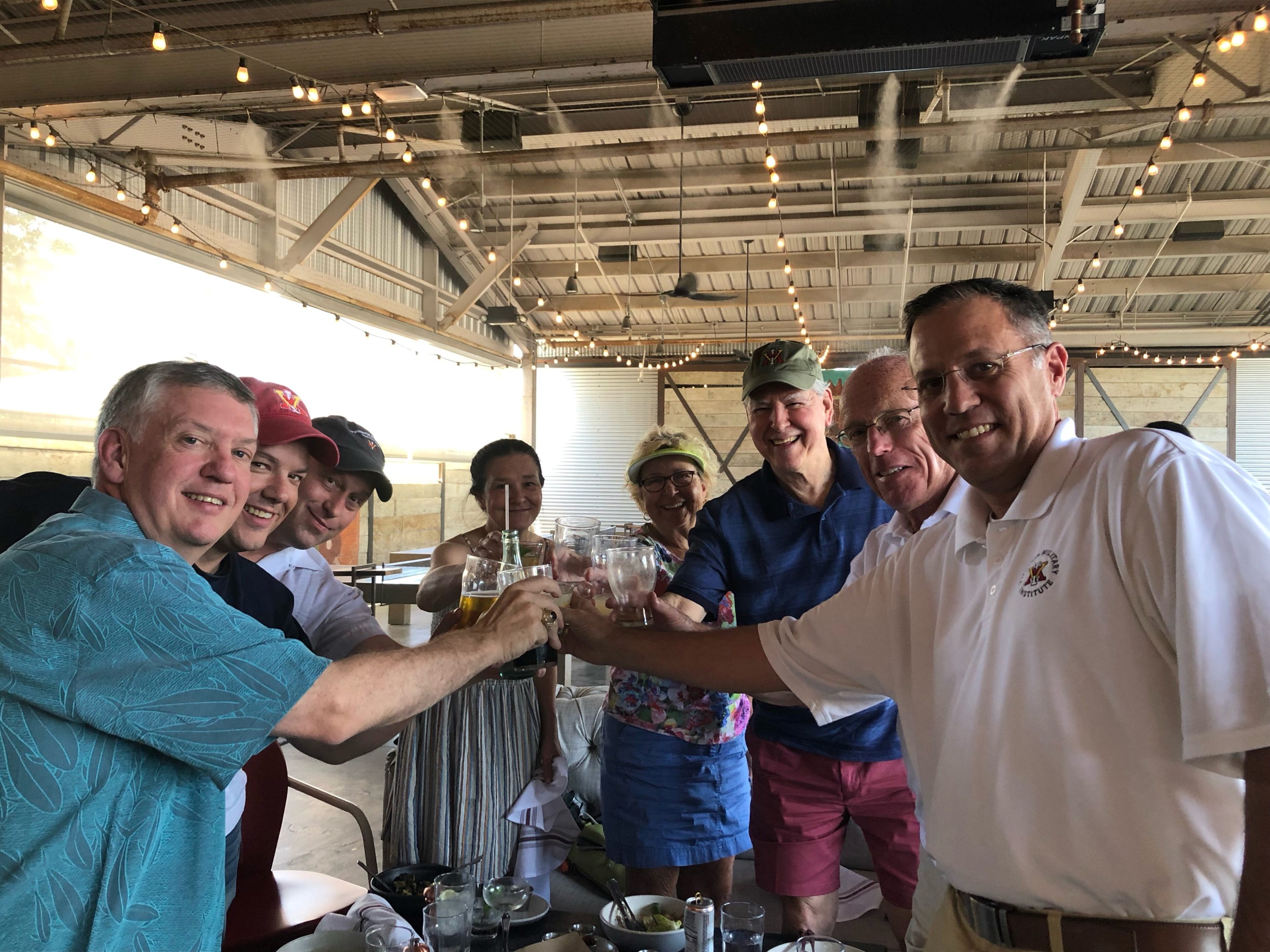 group of people raising a toast and smiling