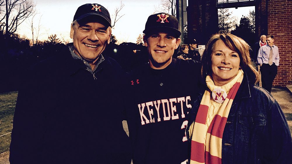 Jordan Tarsovich and his parents posing together and smiling.