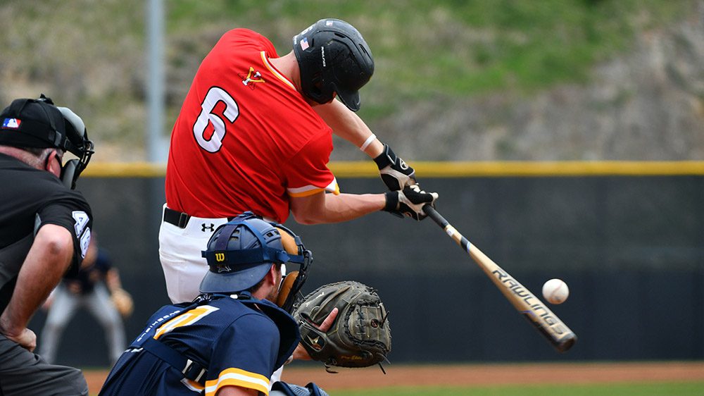 Baseball player hitting ball with bat.