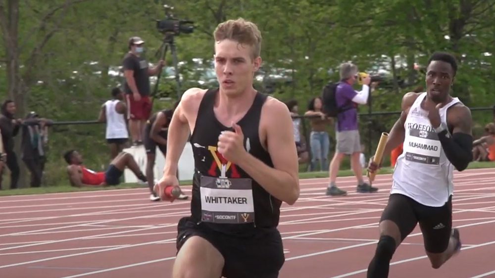 Track athletes running race on outdoor track.