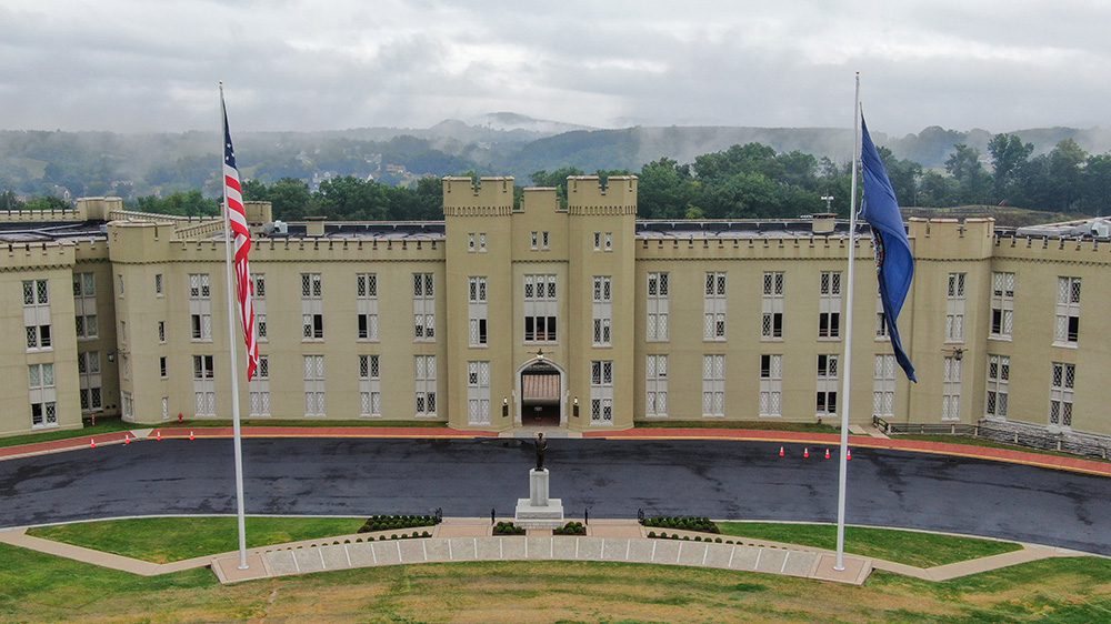 wide shot of new barracks with flag poles on either side, and statue of Gen. George C. Marshall in the center.