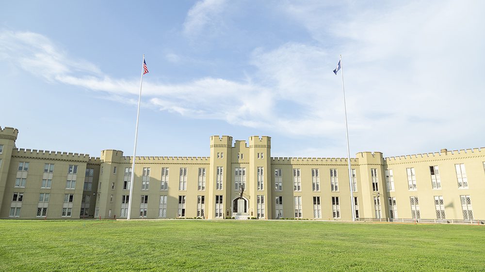 wide shot of new barracks with flag poles on either side, and statue of Gen. George C. Marshall in the center.