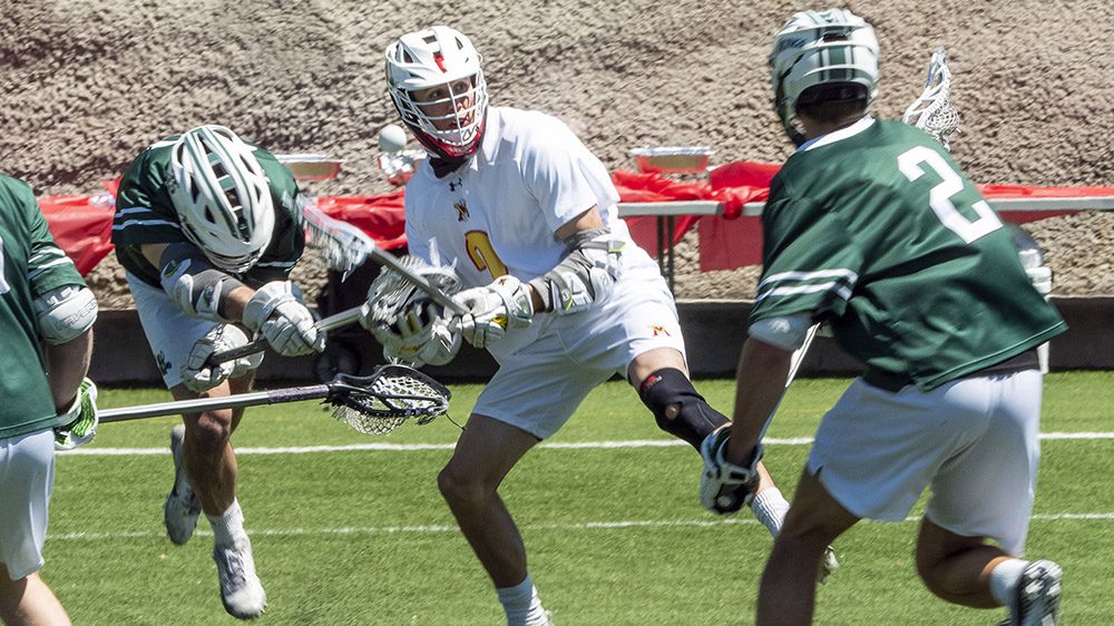 Lacrosse player catching ball with lacrosse stick.