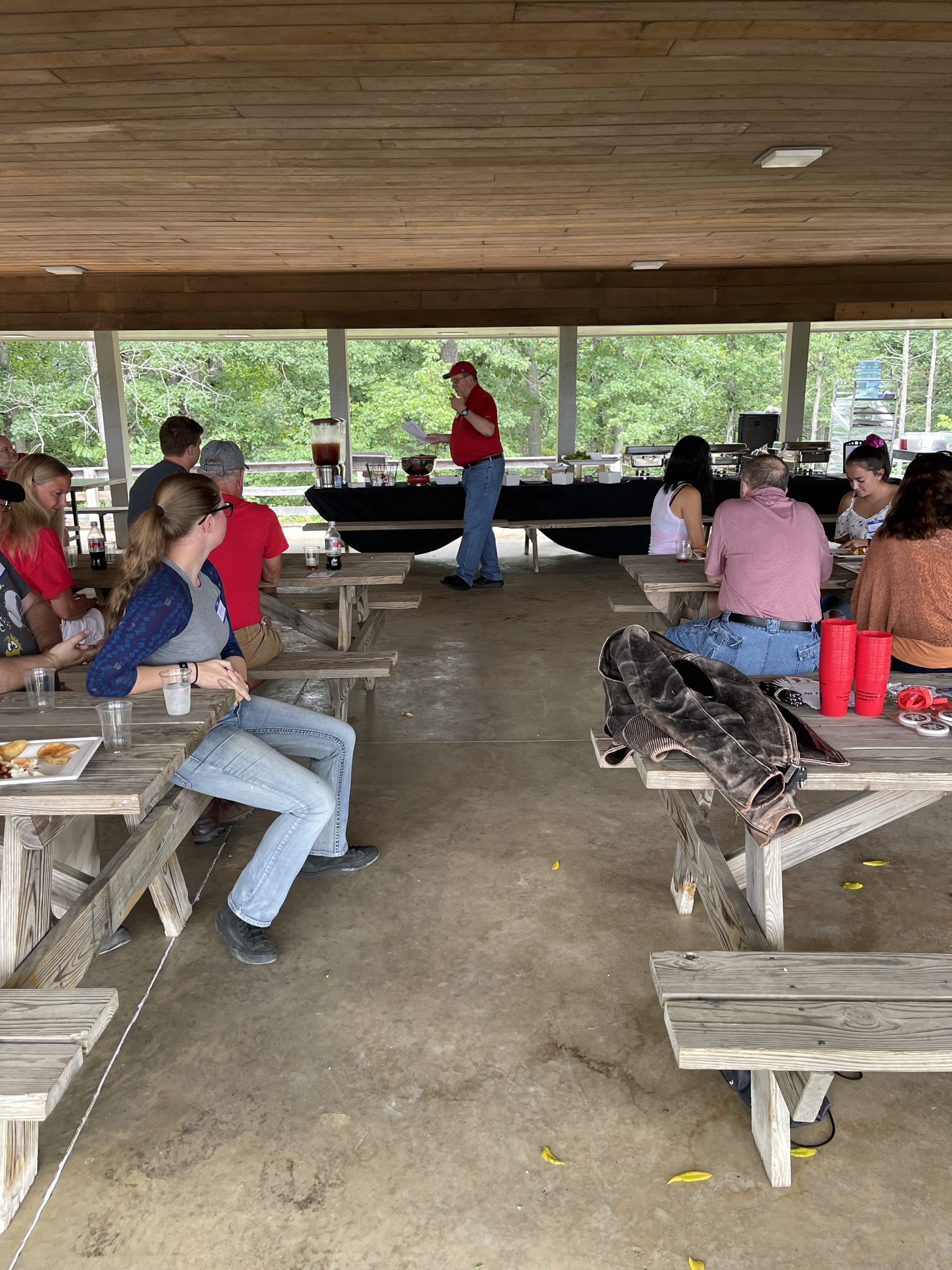 people sitting at picnic tables