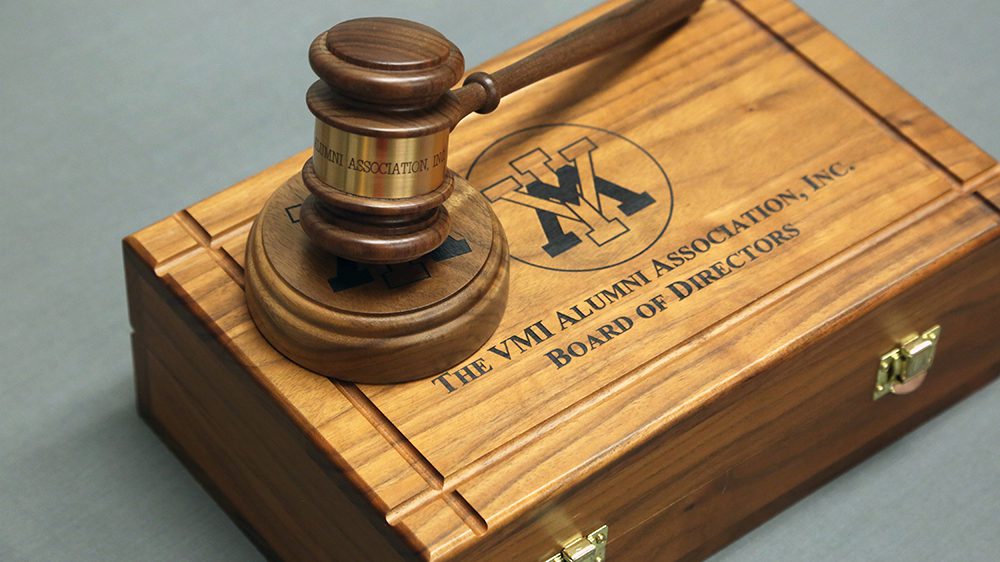 wooden gavel on top of wooden box with VMI spider and 