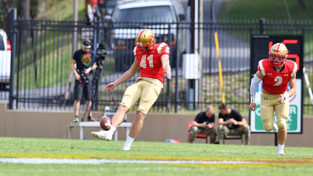 athlete kicking a football