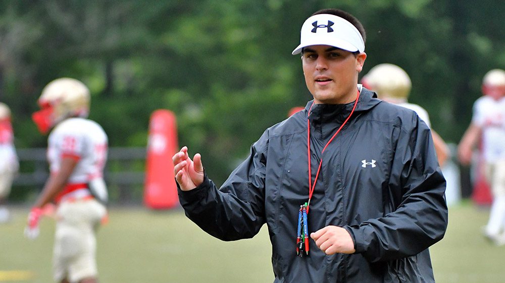 Coach Billy Cosh instructing from sideline.