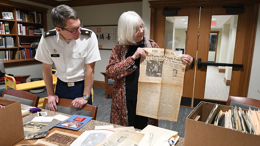 two people reviewing historical documents