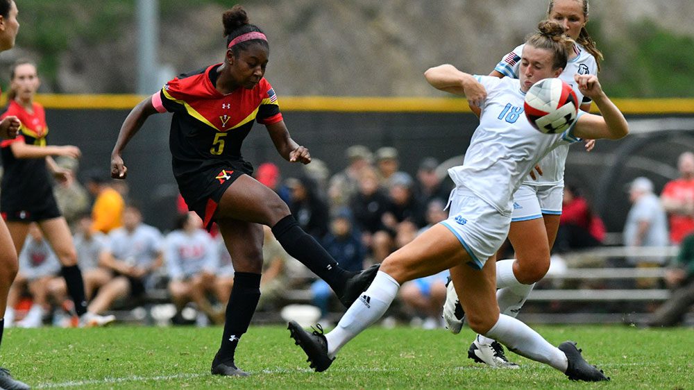 two female soccer players mid-game