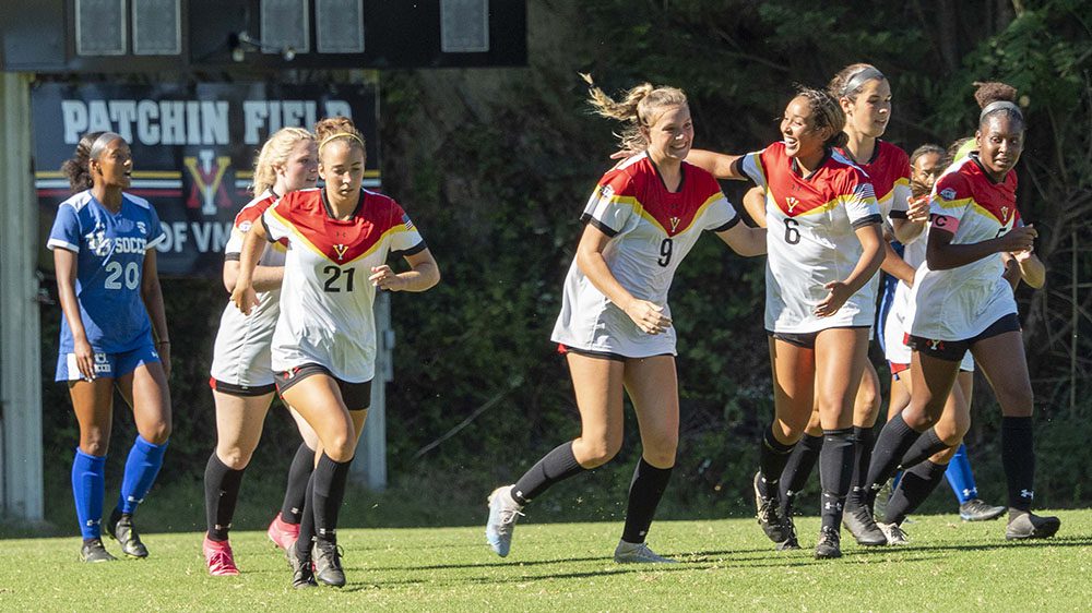 female soccer players cheering and running