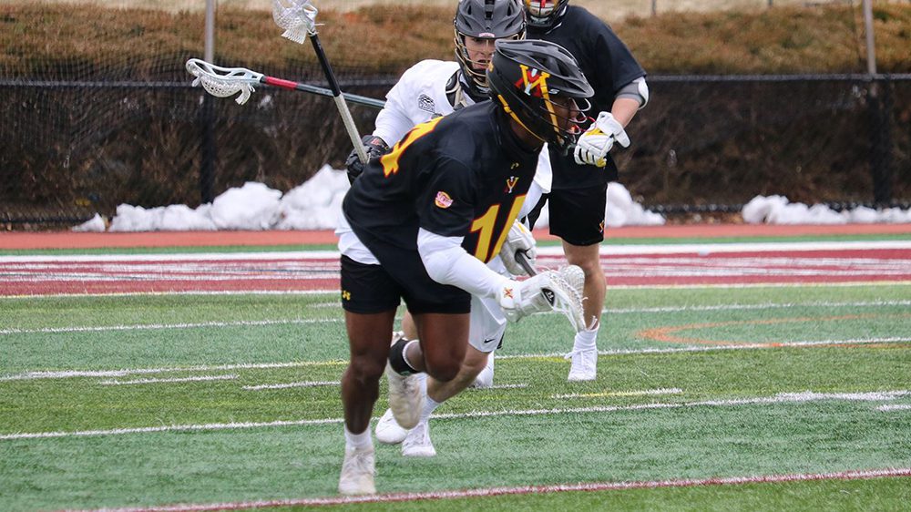 Lacrosse player catching ball with lacrosse stick.