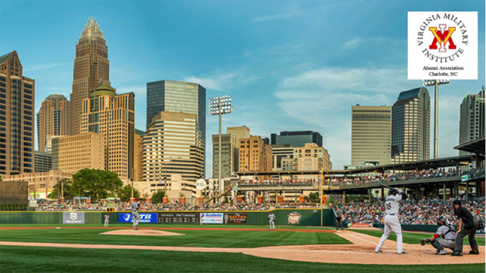 Players on baseball field with Charlotte skyline in background.