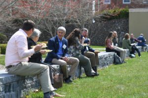 Attendees talking and enjoying an outdoor lunch outside Marshall Hall during the Environment Virginia Symposium.