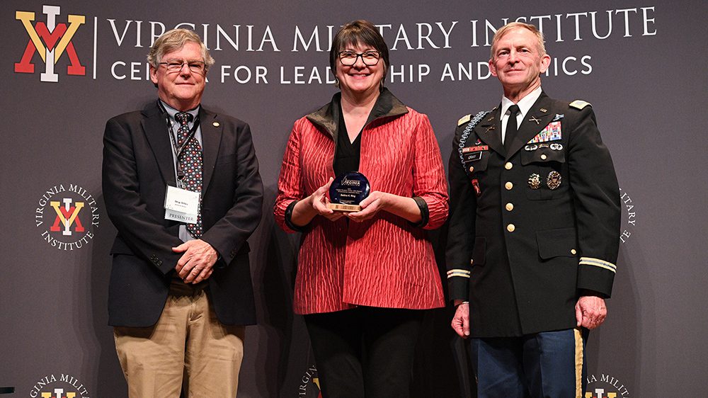 Bettina Ring, chief sustainability and diversity officer for the Sustainable Forestry Initiative, holding the Capt. Ron Erchul Environmental Leadership Award during the Environment Virginia Symposium. With Ring are Skip Stiles, the 2021 Erchul Award recipient, and Col. Dave Gray, Ph.D., Center for Leadership and Ethics director.