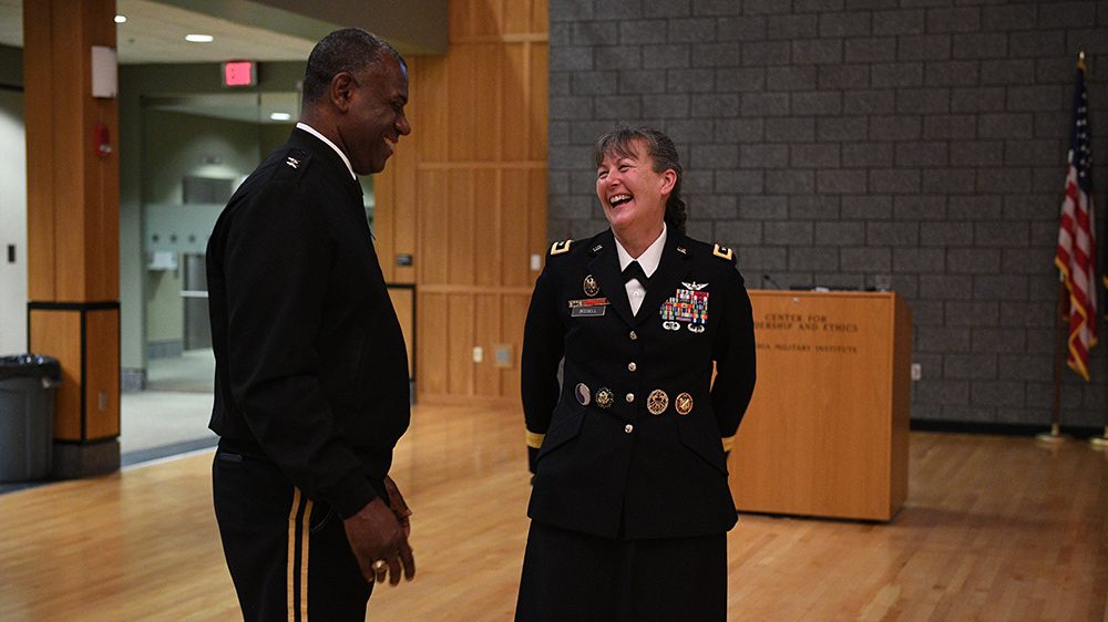 Maj. Gen. Marti Bissell standing and laughing with Maj. Gen. Cedric T. Wins ’85, superintendent, during her visit to post during Women’s History Month.