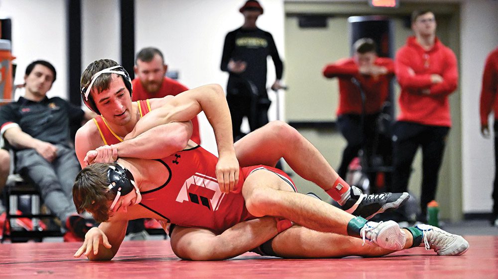 Two cadet-athletes in wrestling match.