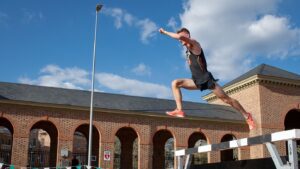 Gavin Jenkins ’22 jumps over a hurdle at the Colonial Relays in Williamsburg, Virginia.