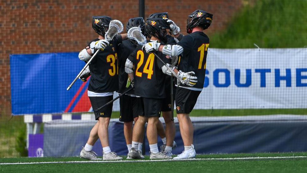 VMI lacrosse players gather in a huddle.