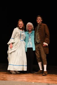 Lauren Wolf ’22 and Matthew Frazier ’23 pose for a photo with Joellen Bland, longtime theatre director.
