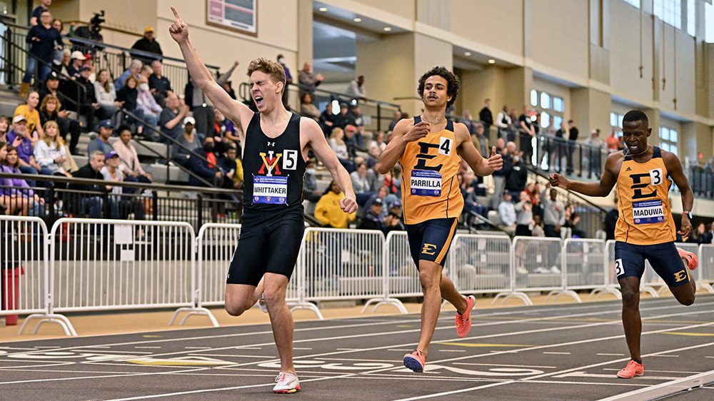 Athletes completing a race on indoor track.