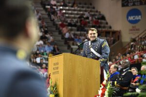 Chris Hulburt ’22, valedictorian, smiles behind podium.