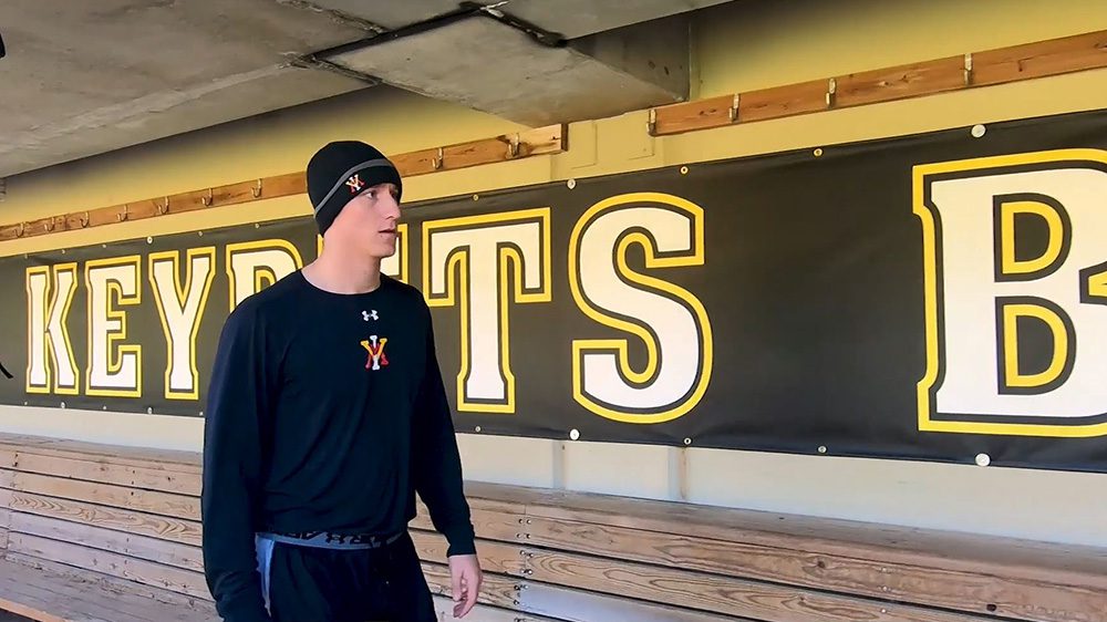 Josh winder walking in dugout along wall that reads 