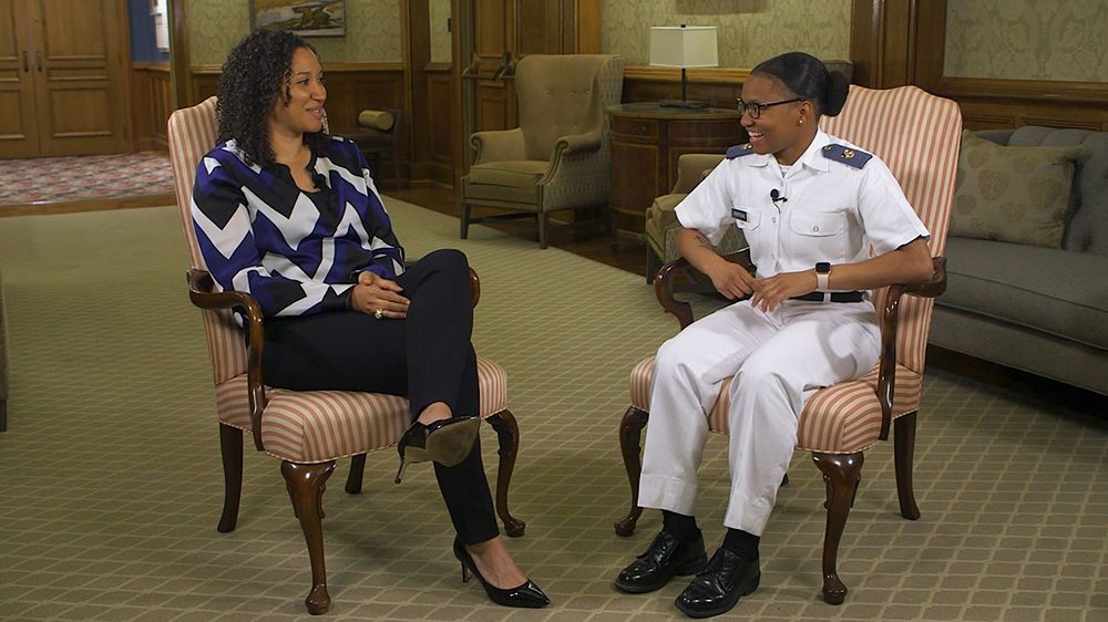 Tamara Ferguson '04 and Eleyah Armstrong '25 seated next to each other, smiling and talking.