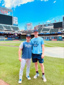 Josh Winder '19 poses for a photo with Casey Dykes on baseball field.