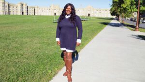 Shelly Pauling standing on sidewalk with barracks in the background