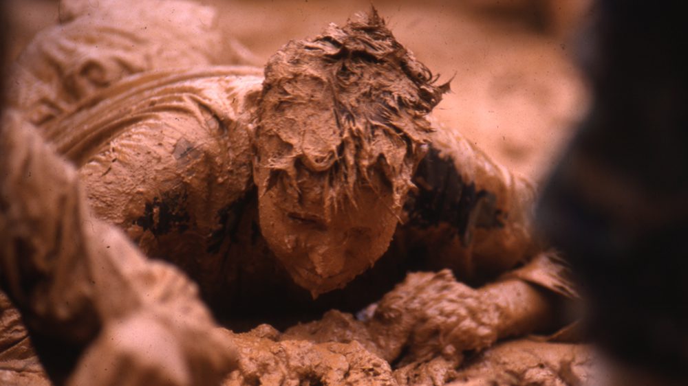 Rat crawling through mud