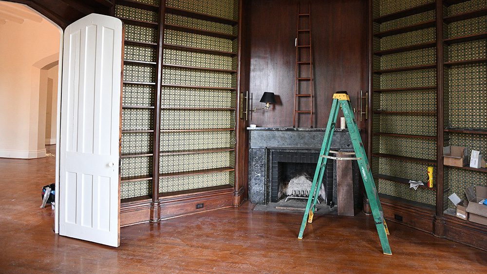 book case against a wall and an open ladder