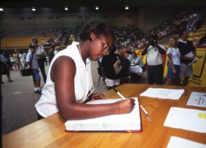 Female signing Matriculation Book