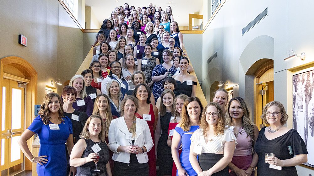 Alumnae gathered in steps, smiling