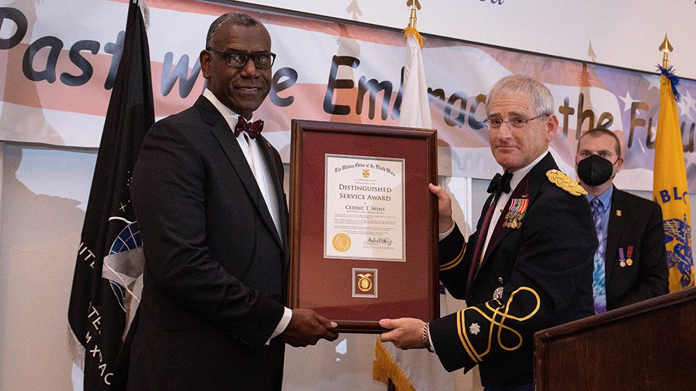 Retired U.S. Army Lt. Col. Michael A. Okin, M.D., commander in chief of the Military Order of the World Wars, presents the 2022 MOWW Distinguished Service Award to Maj. Gen. Cedric T. Wins ’85 during a ceremony in Jacksonville, Florida
