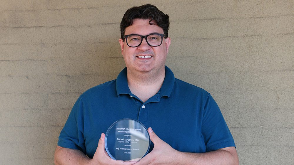 Todd Lee Goen holds the coveted Lily von Klemperer Award bestowed by NAFSA: Association of International Educators