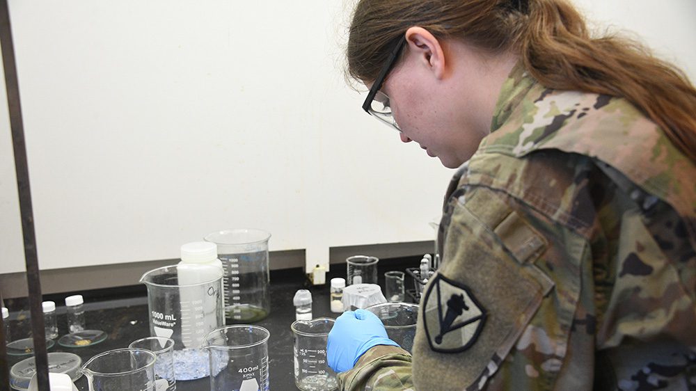 Maj. Shannon Quevedo leaning over counter