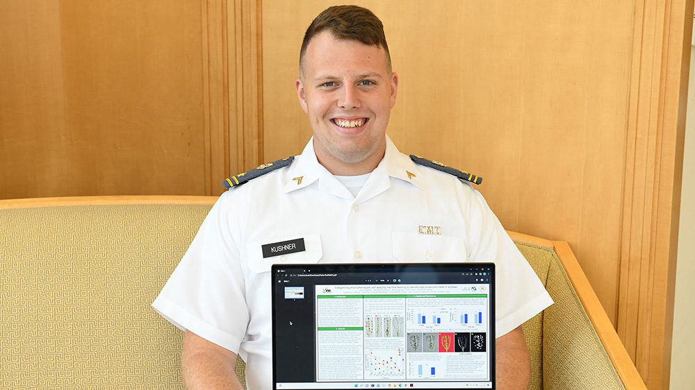 Cadet Chris Kushner ’24 displays his award-winning poster describing his research with soybeans.